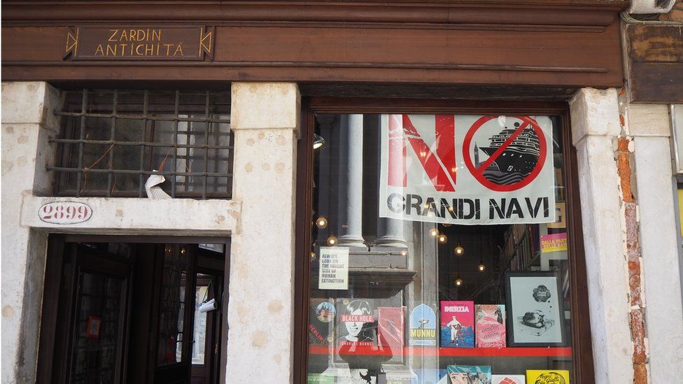 A book shop in Venice displaying the 'No Big Ships' flag