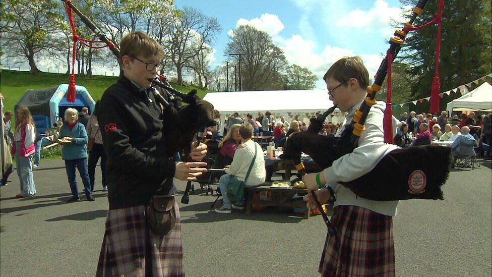 boys play bagpipes in broughton