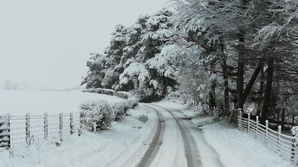 Snowy road and field at Hartside, Northumberland