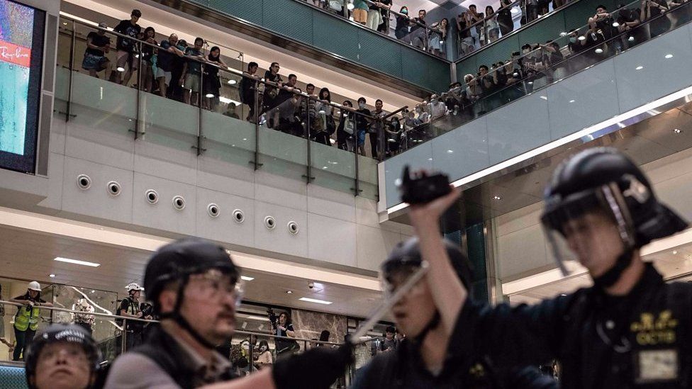 Riot police chased protesters into a shopping mall.