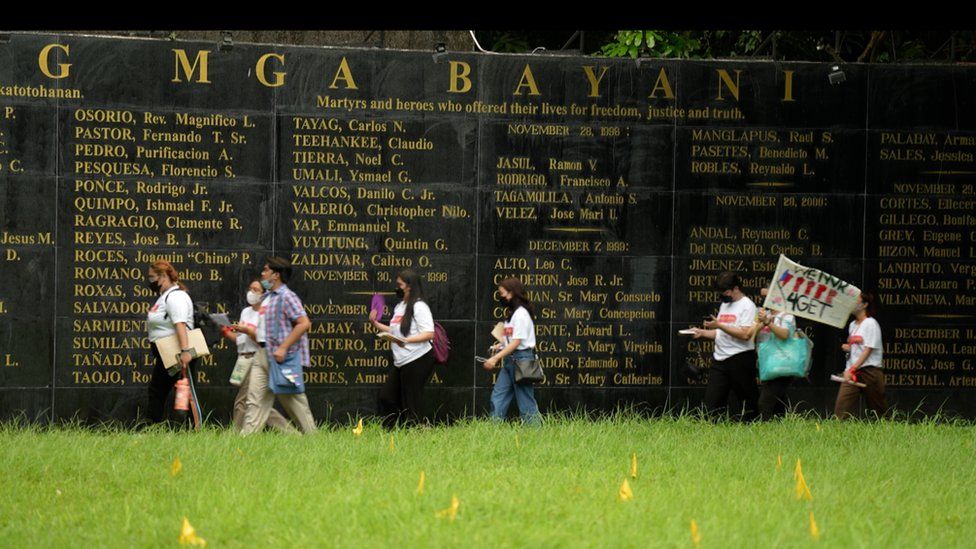 Young Filipinos at a memorial for victims of martial law