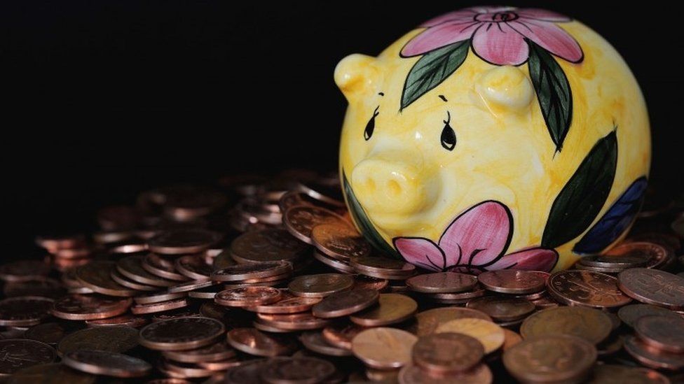 Piggy bank surrounded by 1p pieces