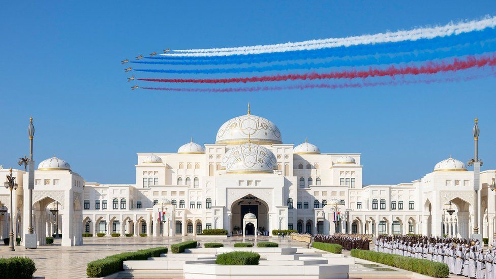 A handout photo made available by the UAE Presidential Court shows A Fursan aerobatic team performs a flyby as Russian President Vladimir Putin arrives for a state visit reception at Qasr Al Watan, in Abu Dhabi, United Arab Emirates, 06 December 2023.