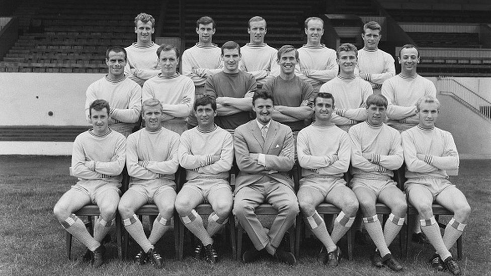 The Coventry City FC football team, UK, 5th August 1965. From left to right. (back row) Brian Hill, John Mitten, Allan Harris, Ron Farmer, Dietmar Bruck; (middle row) George Curtis, Ken Keyworth, Bob Wesson, Bill Glazier, Mick Kearns, John Sillett; (front row) Ronnie Rees, Ken Hale, John Smith, manager Jimmy Hill, George Hudson, Ernie Machin, David Clements. (Photo by Express/Hulton Archive/Getty Images)