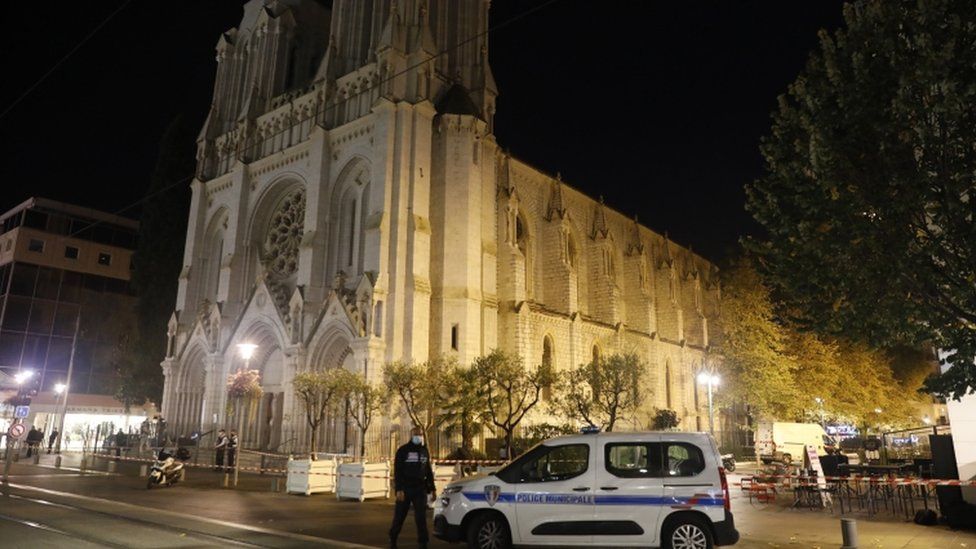 French police officers secure the street near the entrance of the Notre Dame Basilica church in Nice