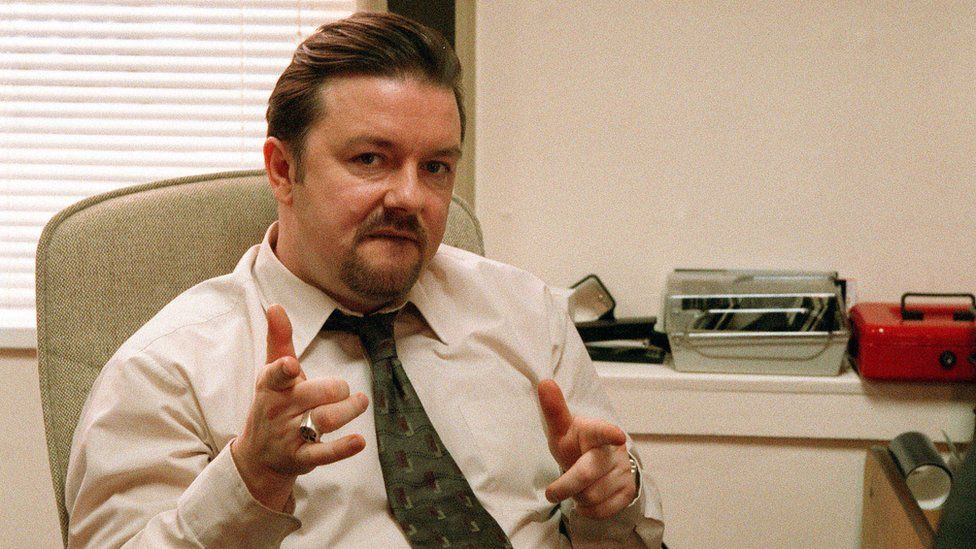 Ricky Gervais playing the character of David Brent in sitcom The Office