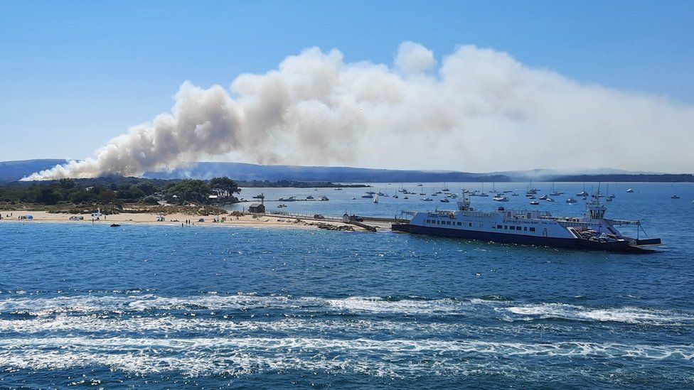 A large plume of smoke from the Studland fire as seen from a ferry in Poole harbour