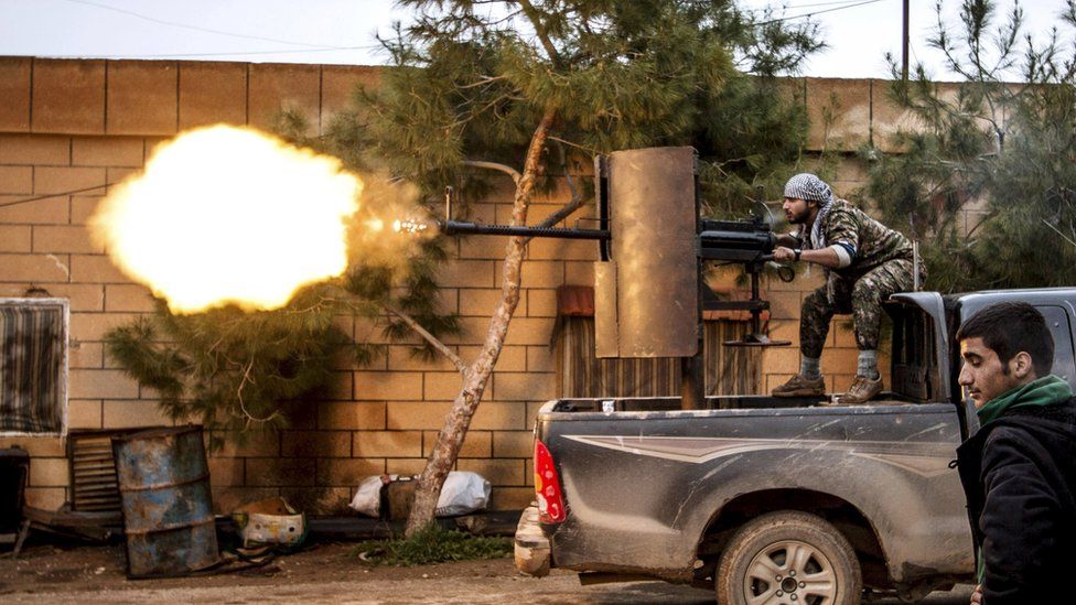 A YPG fighter fires an anti-aircraft weapon at Islamic State militants in Tal Tawil, Syria (25 February 2015)