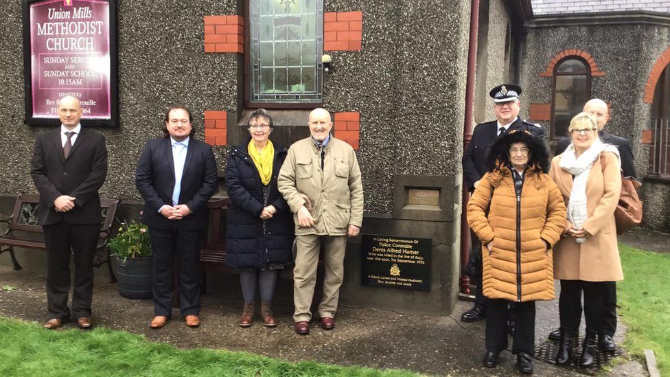 PC Hamer's family standing next to the plaque