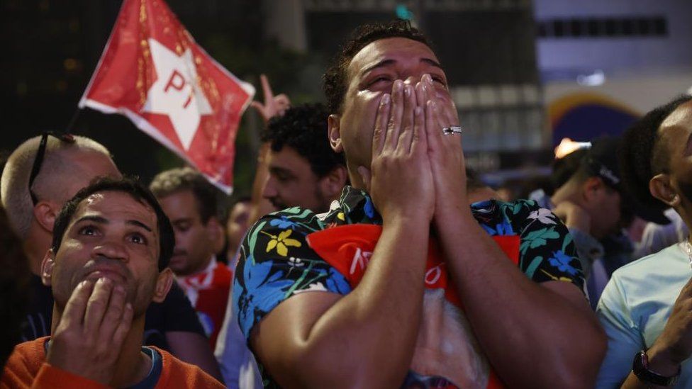 Supporters of former president and presidential candidate Luiz Inacio Lula da Silva celebrate as the partial results of the Brazilian elections come in, on Paulista Avenue in Sao Paulo, Brazil, 02 October 2022.