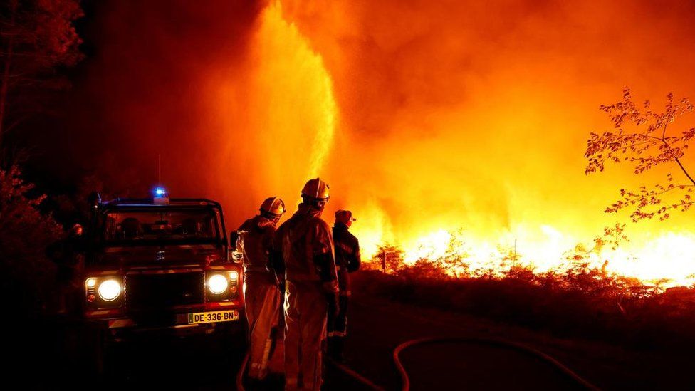 Firefighters work to contain a tactical fire in Louchats, as wildfires continue to spread in the Gironde region of southwestern France, July 17