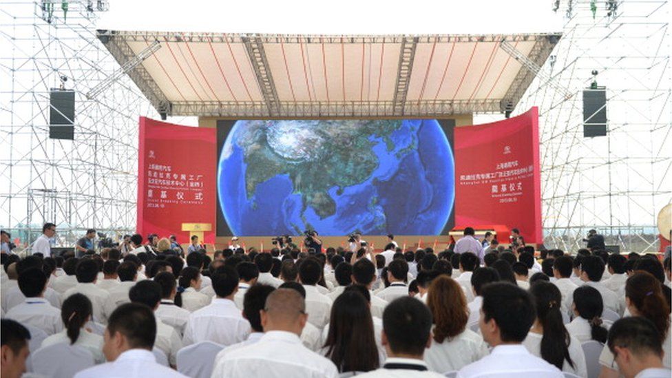 Visitors wait for the start of the ceremony on a $1.3bn General Motors plant in Shanghai on June 19, 2013.
