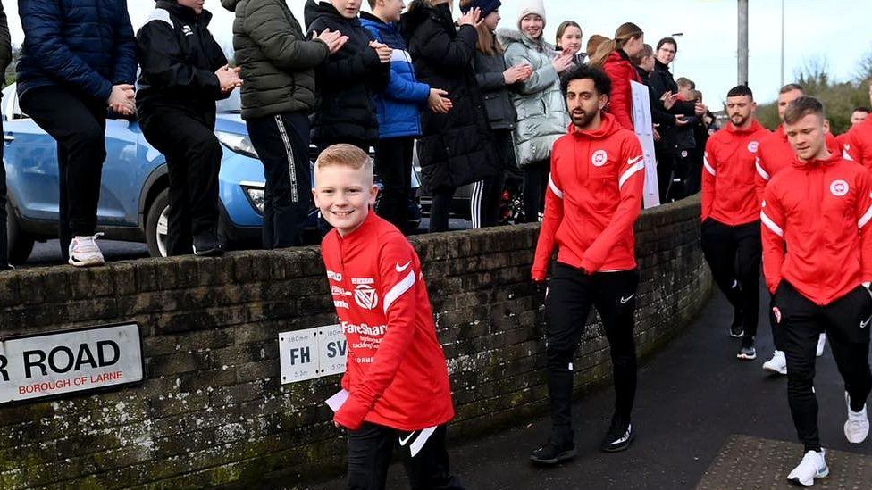 Ben leading walk with local footballers