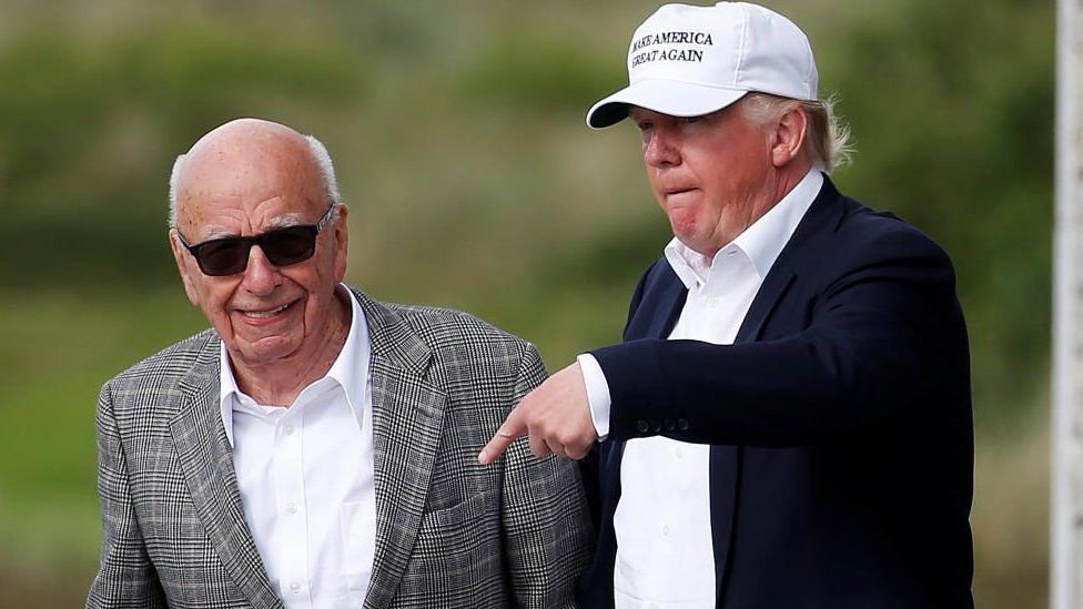 Donald Trump speaks to Rupert Murdoch (L) at Trump's golf course in Aberdeen, Scotland, in June 2016