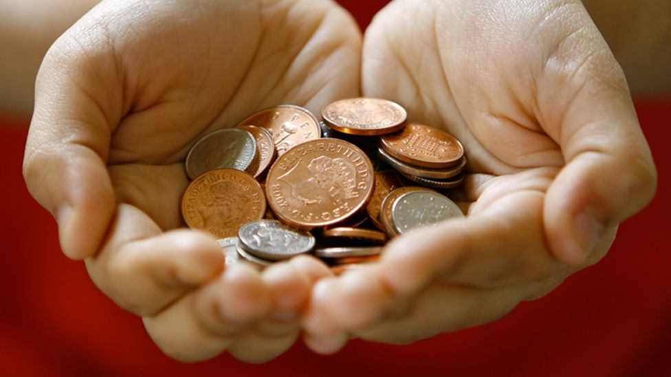 Stock image of hands holding coins