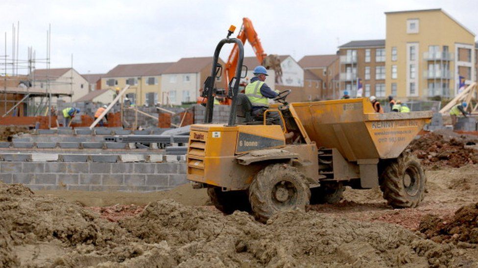 Builders working on a new housing estate