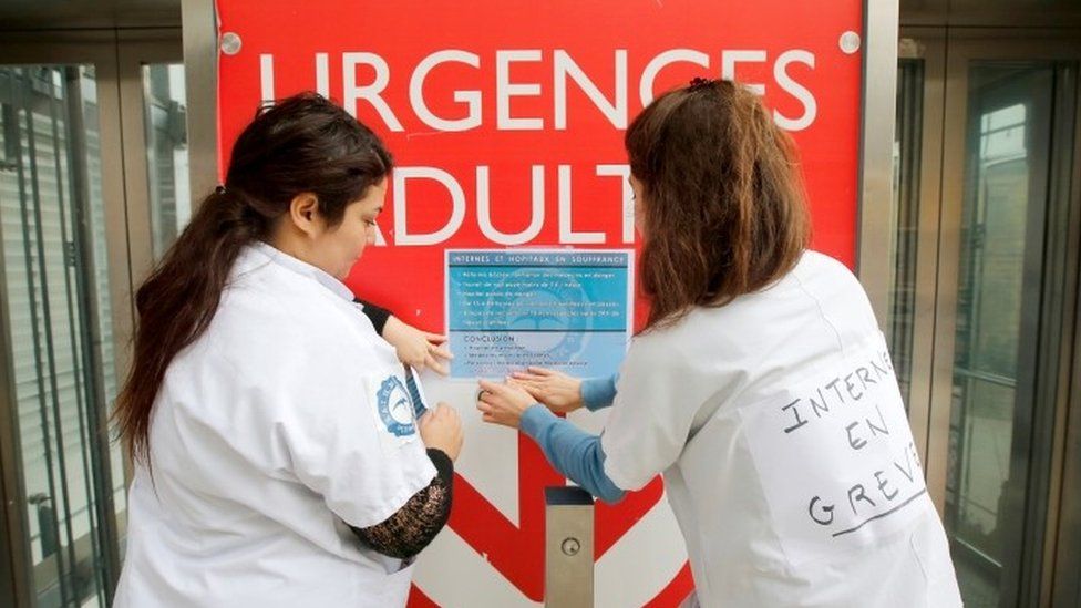 Student doctors on strike place a poster in front of a hospital during a strike to denounce the lack of resources, their working conditions and status in Marseille, France