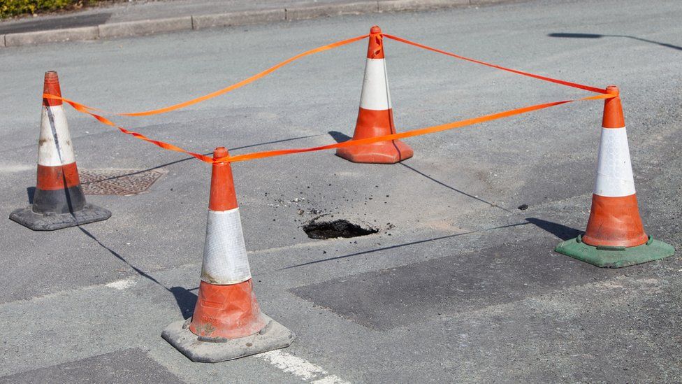 A stock image of a sinkhole opening up in the road in Ambleside, due to being undermined by flood waters