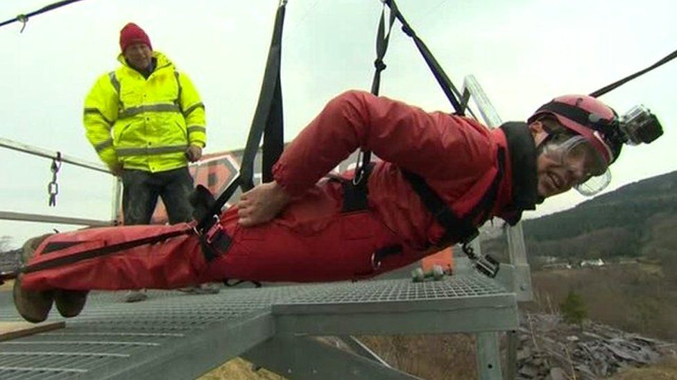 BBC reporter Cemlyn Davies on a zip wire