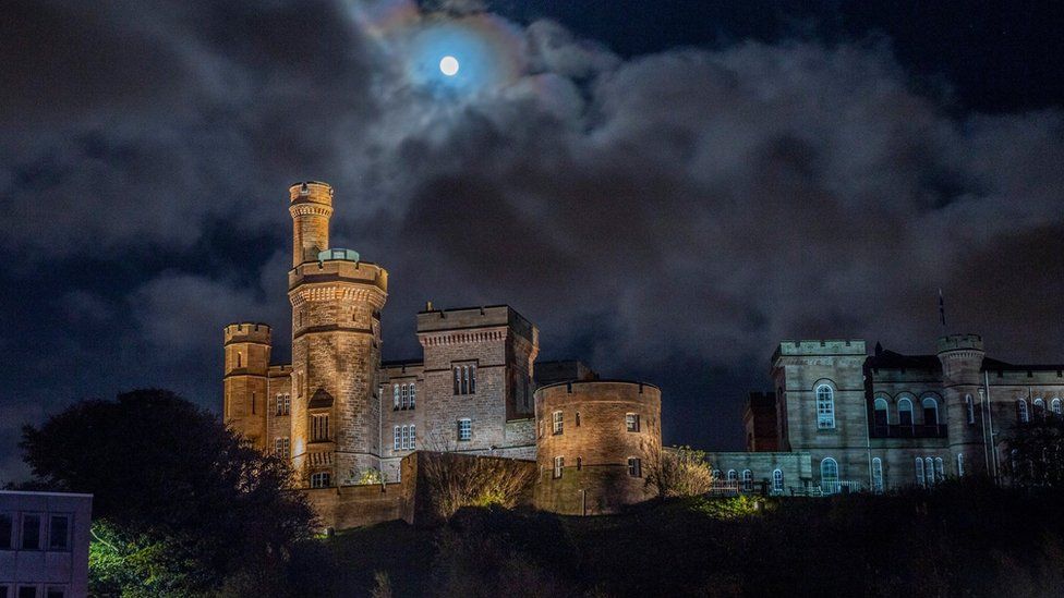 Inverness castle seen from below with the moon high above