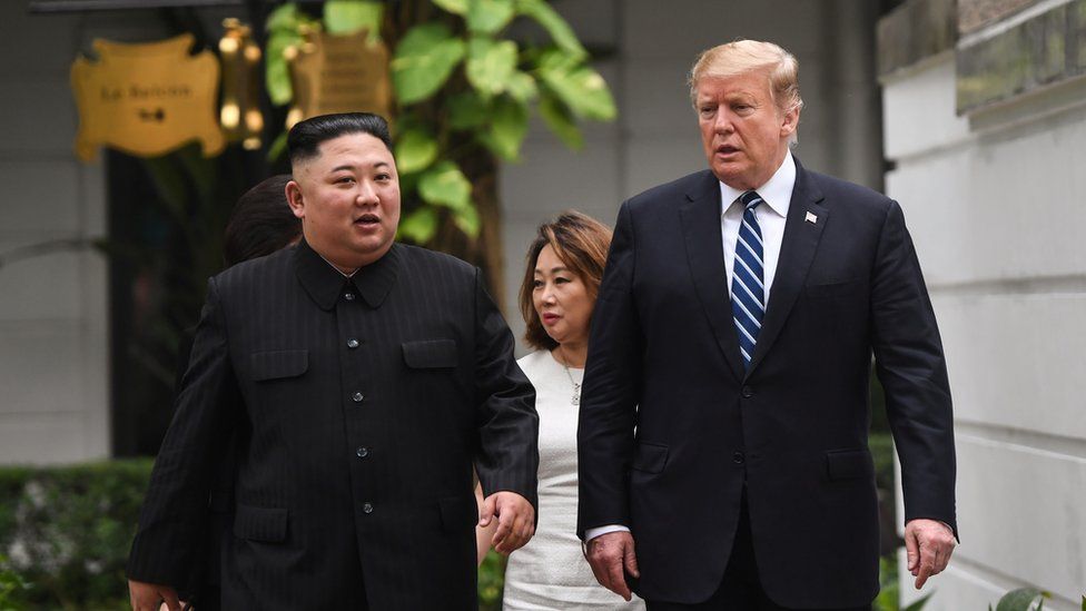 US President Donald Trump (R) walks with North Korea's leader Kim Jong Un during a break in talks at the second US-North Korea summit at the Sofitel Legend Metropole hotel in Hanoi on 28 February, 2019.