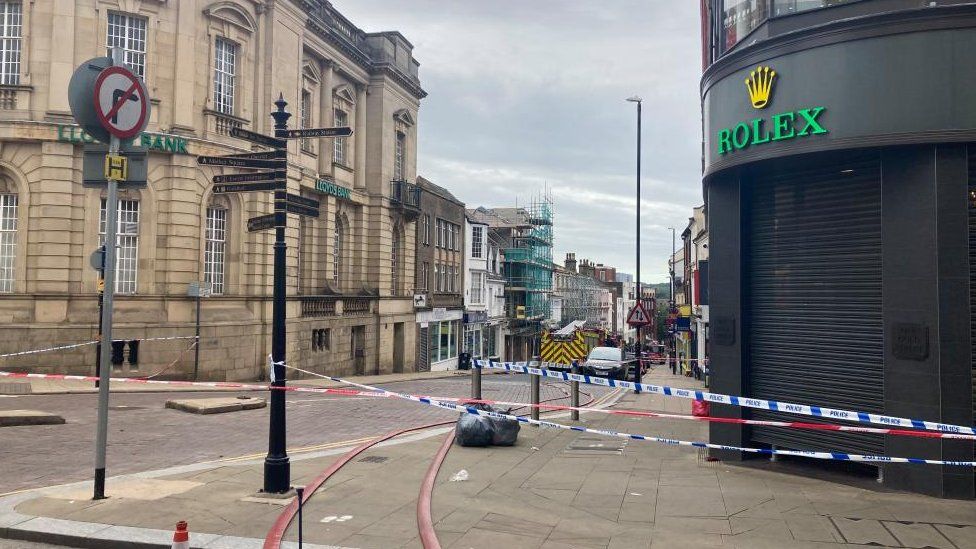 End of town centre street, showing police tape closing the road