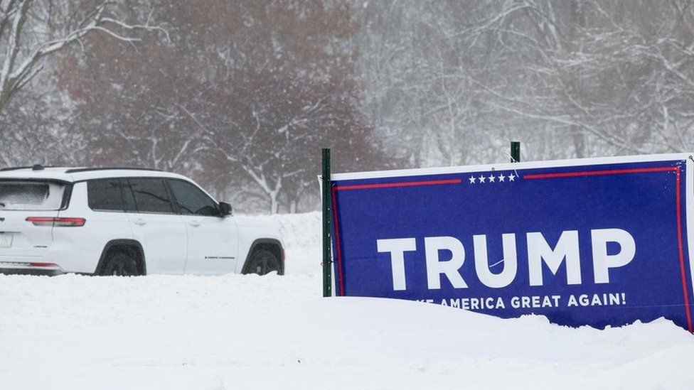 sign sits in the snow outside former U.S. President Donald Trump's campaign headquarters in Urbandale, Iowa