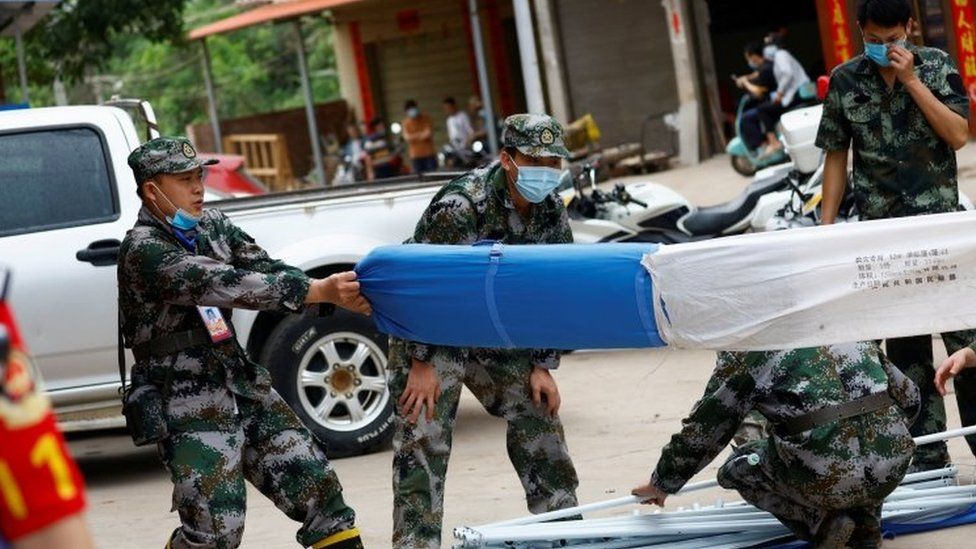 Soldiers set up tents at the operations base of the search for survivors from Flight MU5735