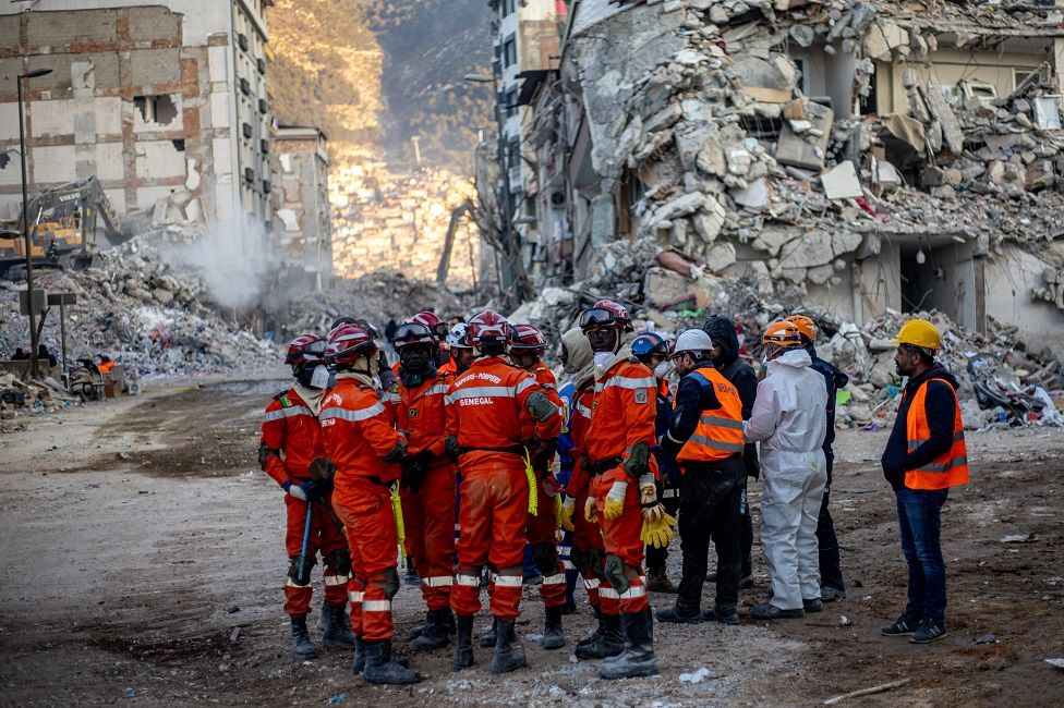 Rescuers from Senegal work at site of collapsed buildings after a powerful earthquake, in Hatay, Turkey.