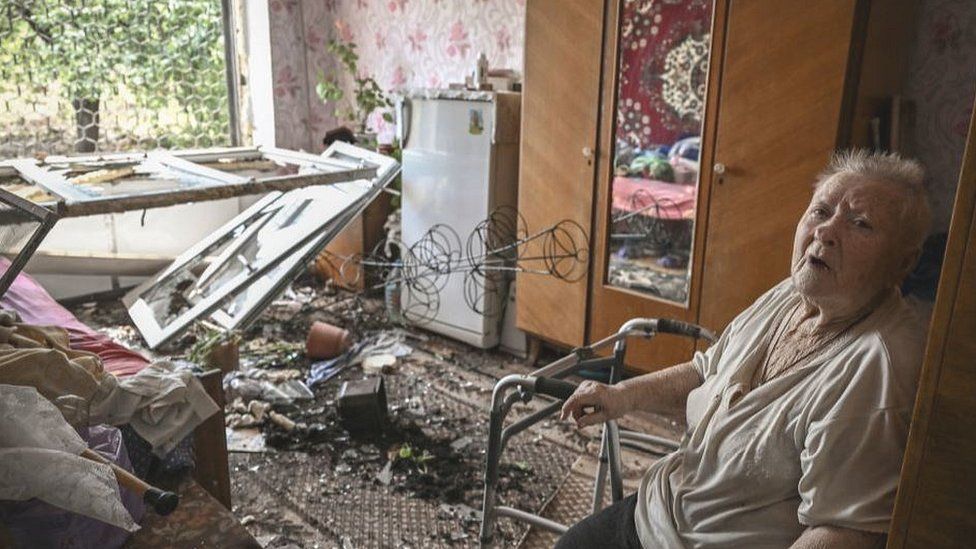 Woman in bombed-out apartment in Soledar, eastern Ukraine, 4 Jun 22