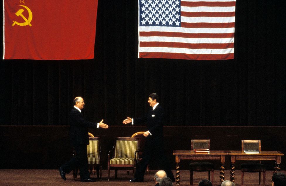 Soviet Premier Mikhail Gorbachev (L) and US President Ronald Reagan stride across the stage towards each other at their first summit meeting November 1985 in Geneva, Switzerland.