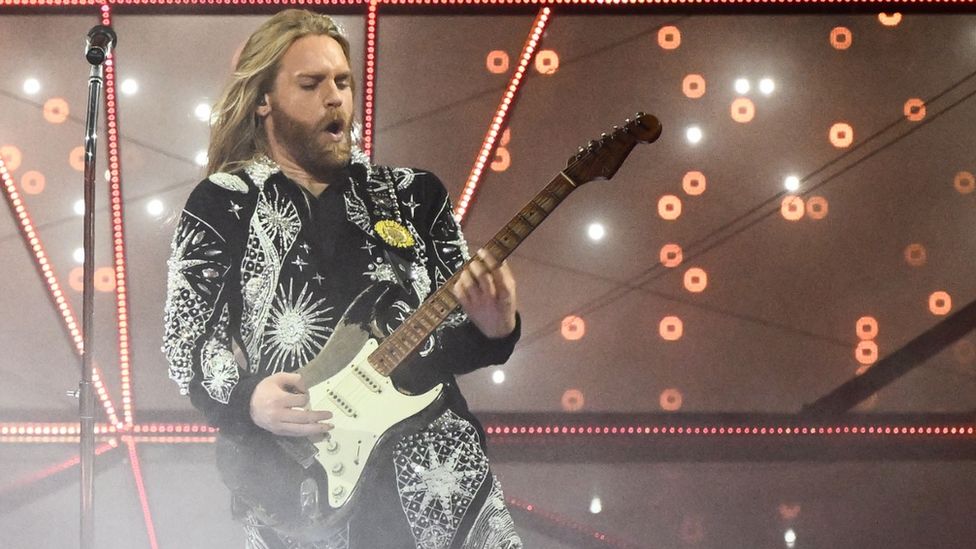 Eurovision's 2022 runner-up Sam Ryder plays the guitar on stage during his performance in Turin