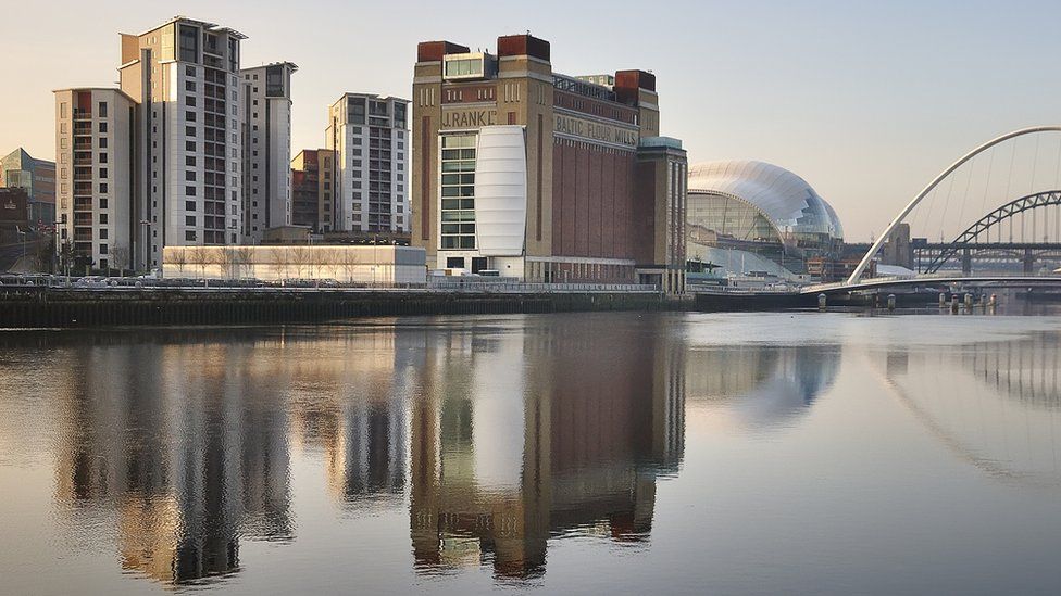 Buildings on Gateshead riverside reflected in the river