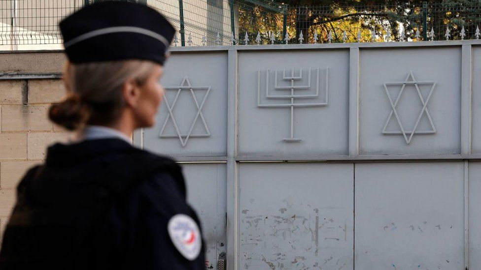 A French police officer stands guard in front of the Synagogue of Sarcelles, Paris's suburb, on 11 October 2023