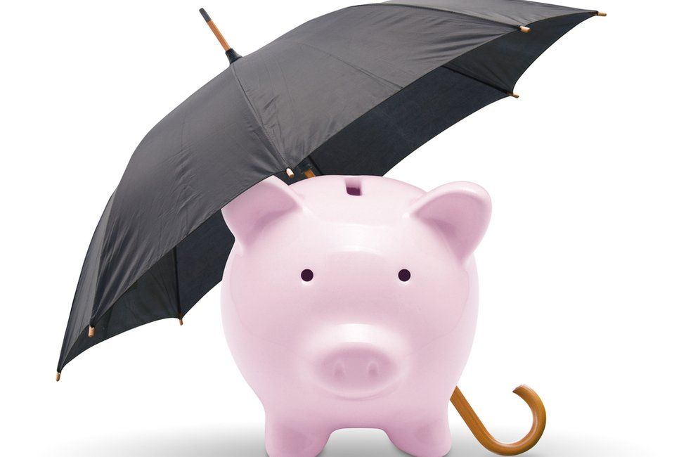 piggy bank covered by umbrella