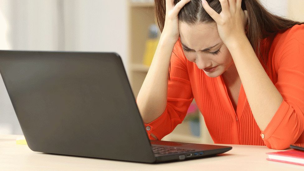 Woman sad at laptop