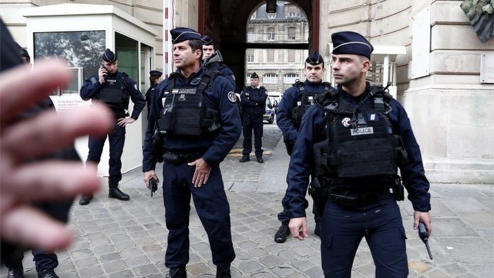 French police and security forces stand outside Paris police headquarters on 3 October 2019.