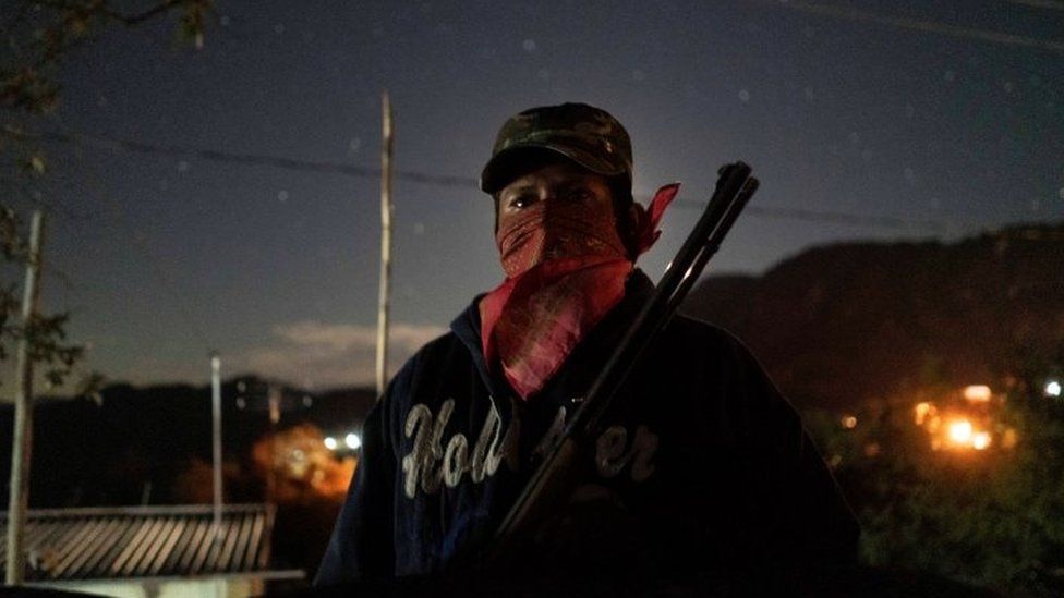 A community police agent, poses for a photo as he guards a check point in Ayahualtempa, Mexico, January 30, 2020.