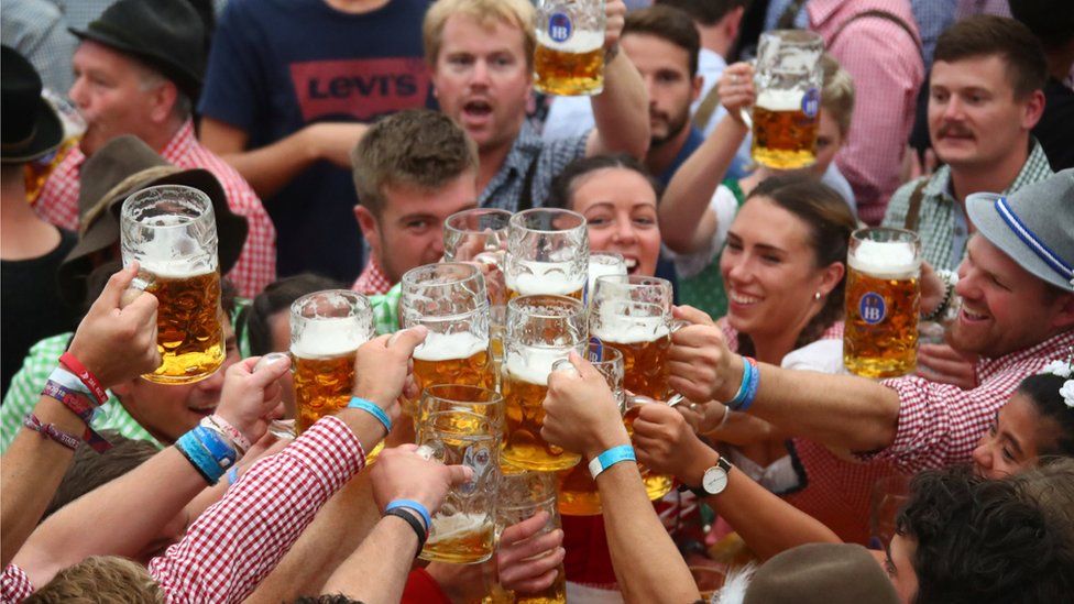 visitors toast with beers