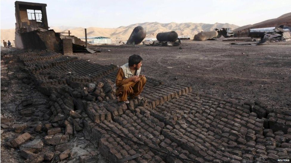 Someone inspects the site of a gas explosion on the edge of Herat city, Afghanistan, 25 August 2015