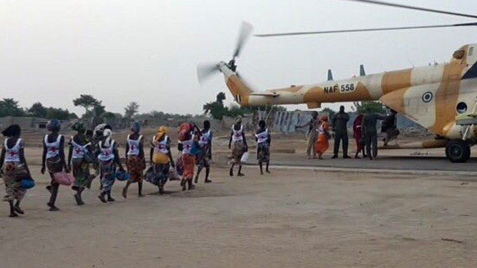 Some of the 82 released Chibok girls board an aircraft