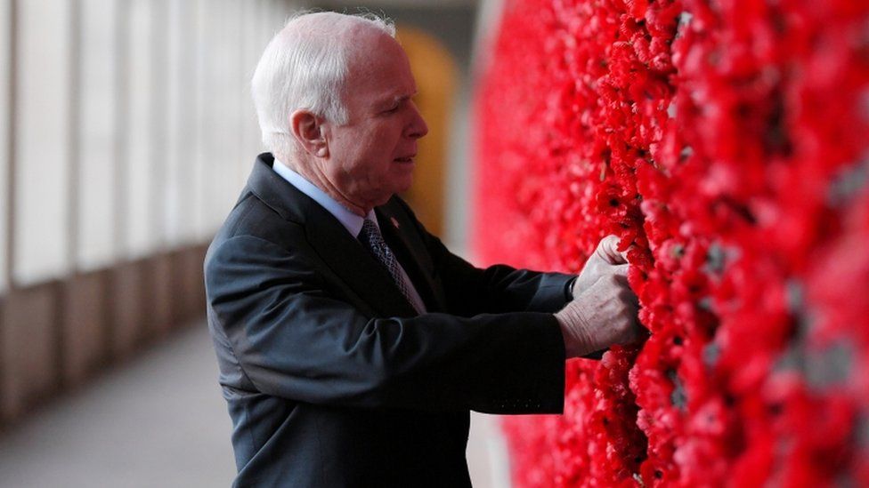 Senator John McCain places a poppy on the Roll of Honour wall during a visit to the Australian War Memorial in Canberra, Australia, May 29, 2017.