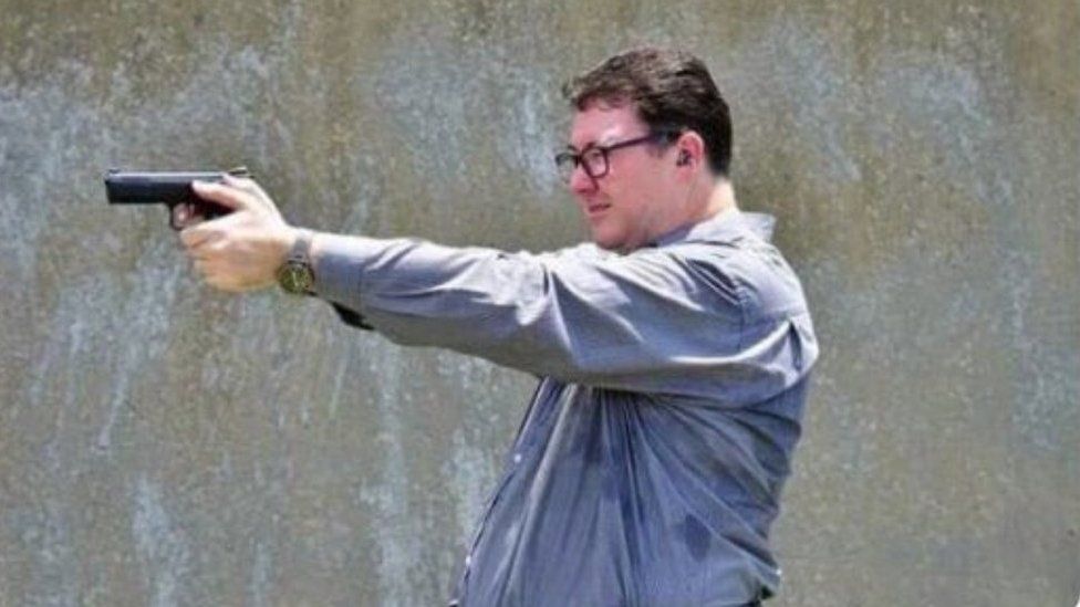 A screenshot of a Facebook post showing Australian MP George Christensen aiming a gun
