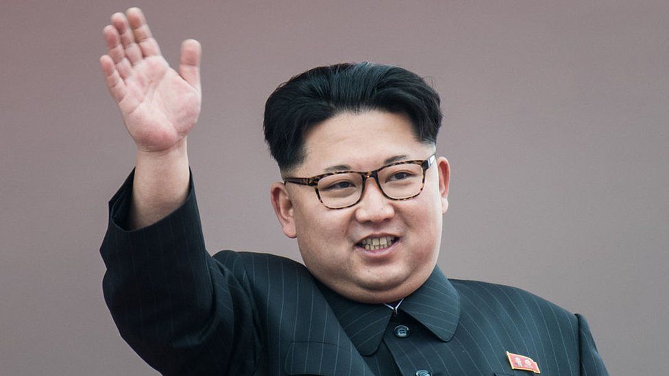 North Korean leader Kim Jong-Un waves from a balcony of the Grand People's Study House