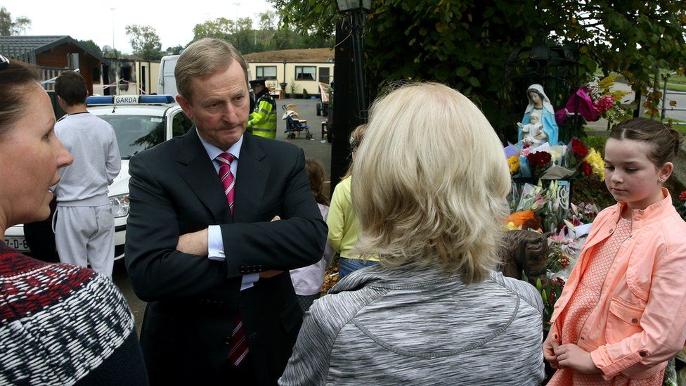 Irish Prime MInister Enda Kenny speaks to people at the scene of the fire
