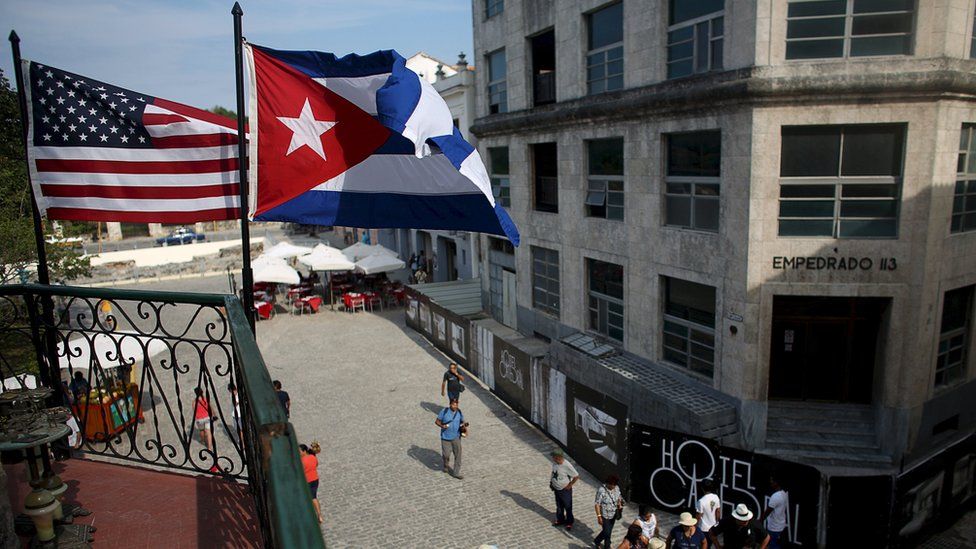 U.S. and Cuban flags hang on the terrace of a restaurant in downtown Havana, Cuba, March 17, 2016