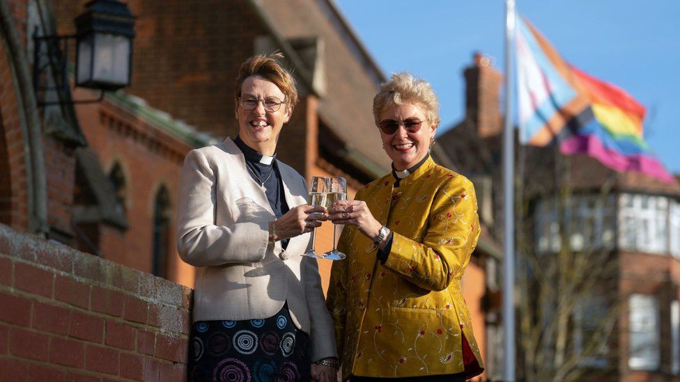 Catherine Bond (left) and Jane Pearce toasting after their blessing at St John the Baptist Church in Felixstowe, Suffolk