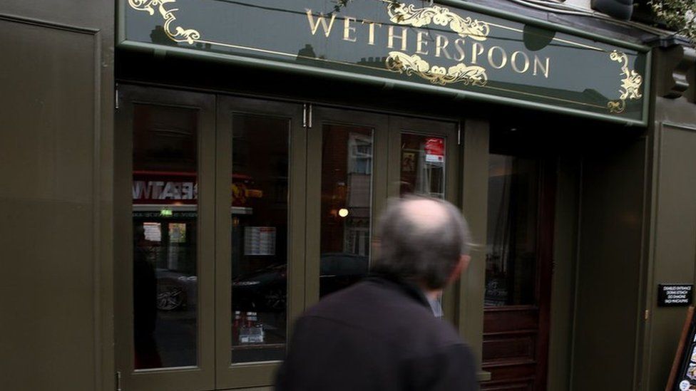 A man walks past a Wetherspoon in Dublin