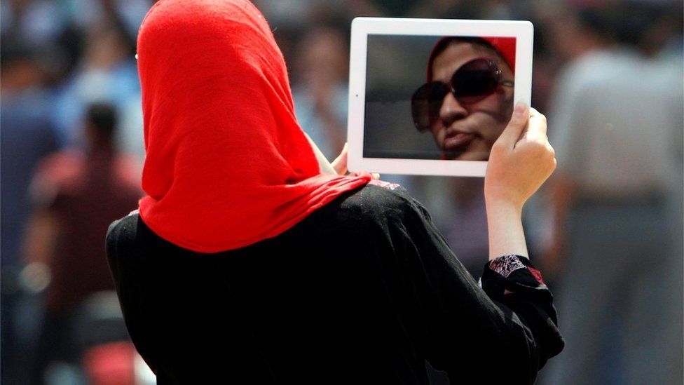 An Egyptian woman used her tablet to video protesters in Cairo's landmark Tahrir Square, 3 June 2012