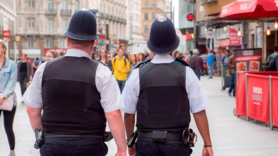 Two Met police officers from behind